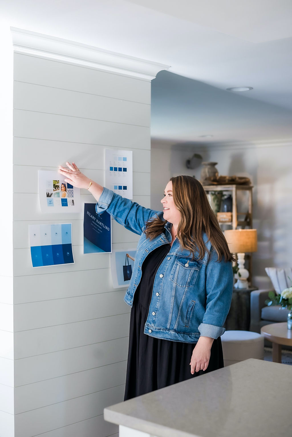 Hilary Hartling reviewing brand strategy materials on a wall